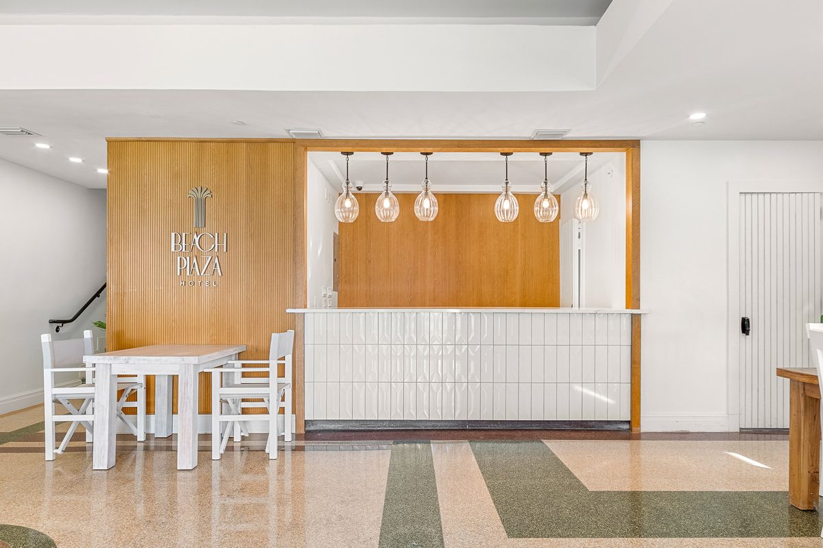 Beach Plaza reception desk with branded wall lettering