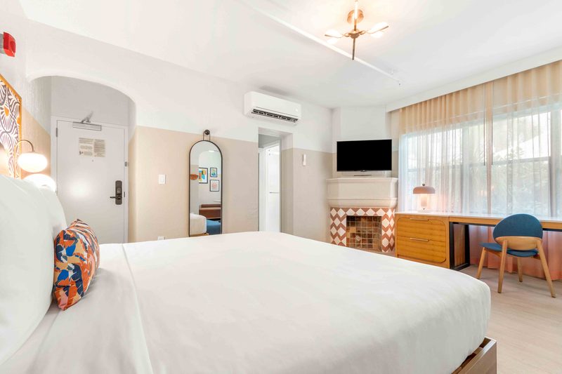 Superior Villa: a king bed beside a tiled decorative fireplace, with a desk by the window